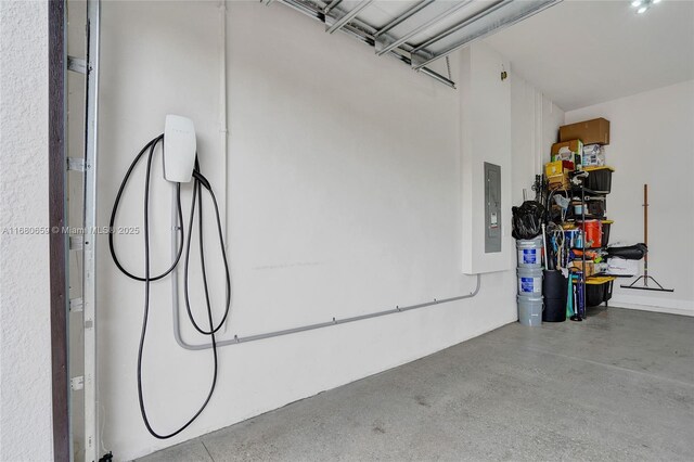 garage featuring electric panel and a garage door opener