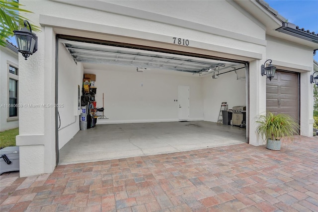 garage featuring decorative driveway