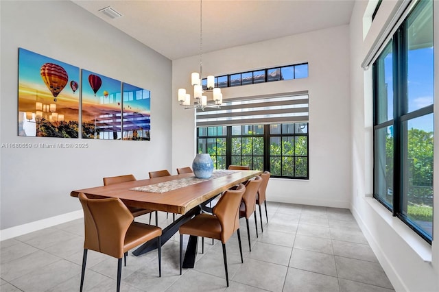 dining room with visible vents, a notable chandelier, baseboards, and light tile patterned floors