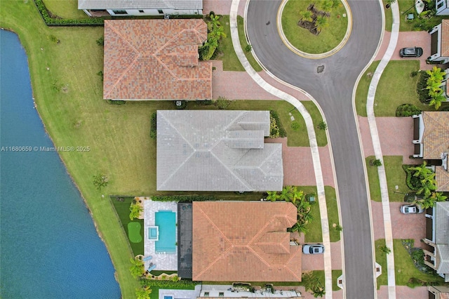 birds eye view of property with a water view