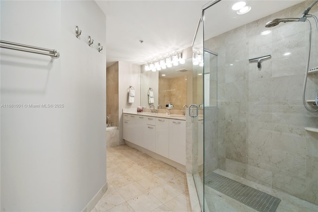 bathroom with vanity and separate shower and tub