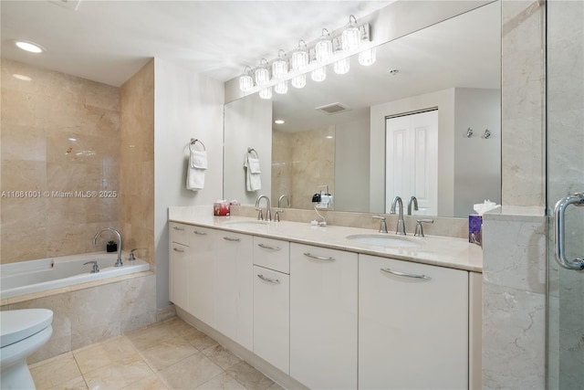 full bathroom featuring vanity, toilet, and separate shower and tub