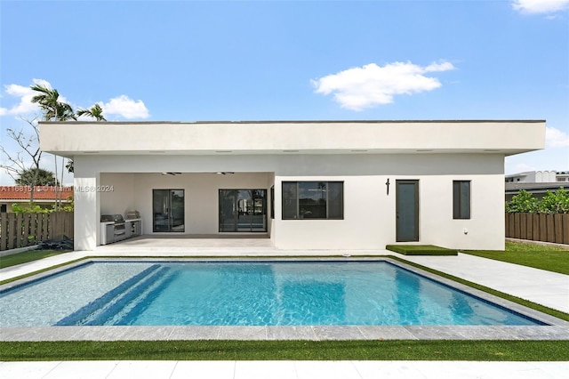 back of house featuring a patio area and a fenced in pool