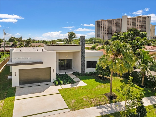 contemporary home with a front yard and a garage