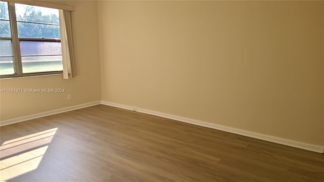 spare room with dark wood-type flooring