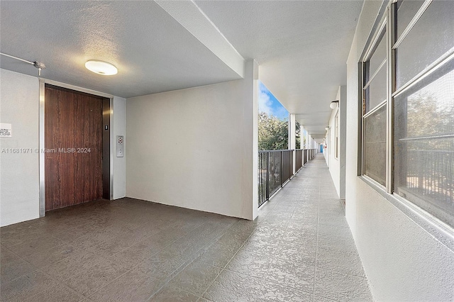 corridor featuring a textured ceiling