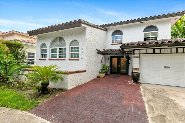 mediterranean / spanish house with a garage