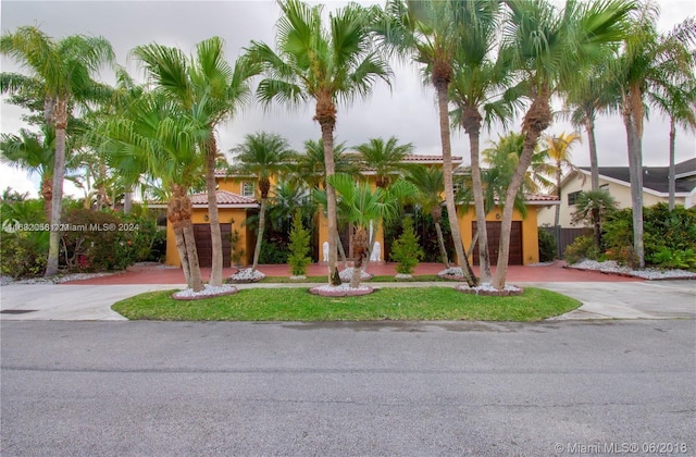 mediterranean / spanish-style home with a front yard