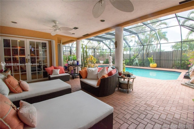 view of swimming pool featuring a patio, a lanai, outdoor lounge area, and ceiling fan