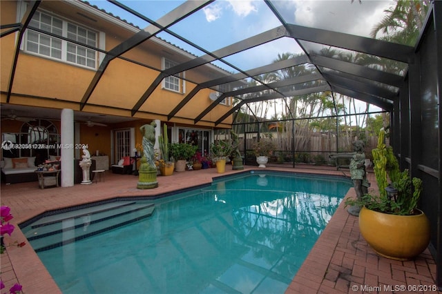 view of swimming pool featuring a patio area and a lanai