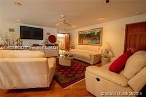 living room featuring hardwood / wood-style flooring and ceiling fan