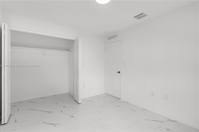 unfurnished bedroom with a closet