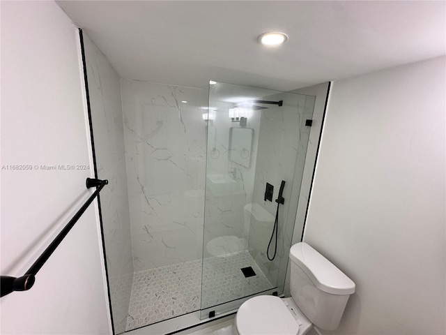 bathroom featuring toilet and walk in shower