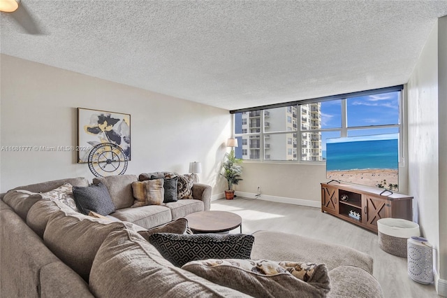 living room with a textured ceiling and expansive windows