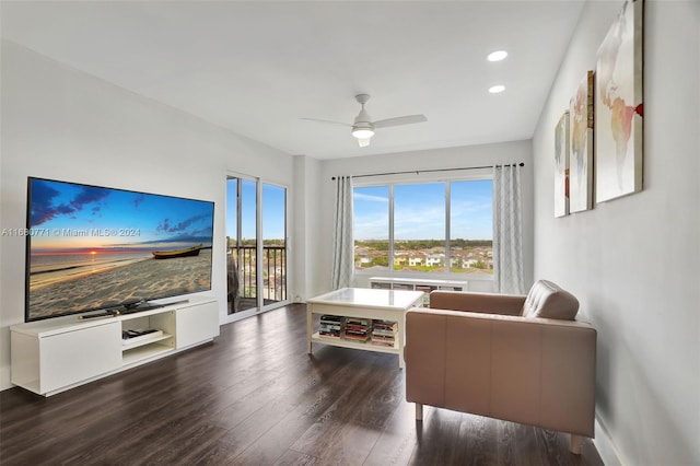 living room featuring ceiling fan and dark hardwood / wood-style flooring