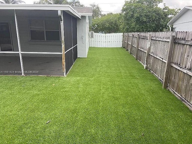 view of yard featuring a sunroom