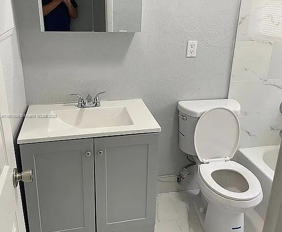 full bathroom with toilet, shower with separate bathtub, and vanity