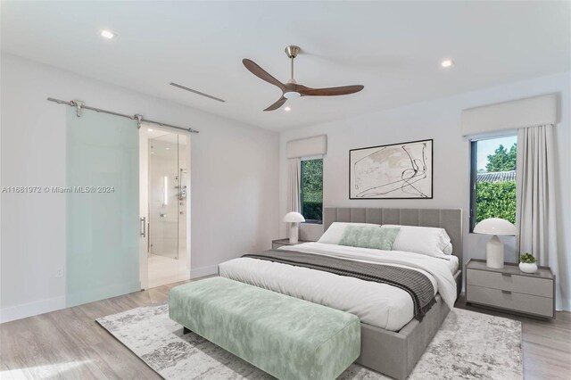 7720 SW 130th St, Pinecrest, FL 33156 - bedroom featuring a barn door, light wood-type flooring, visible vents, and recessed lighting
