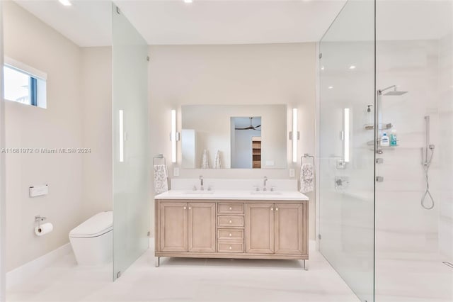 bathroom featuring vanity, a shower with shower door, toilet, and ceiling fan