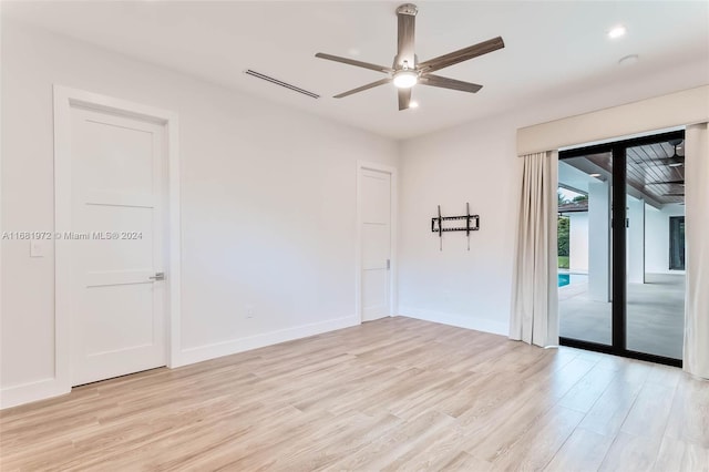 spare room with light hardwood / wood-style floors and ceiling fan