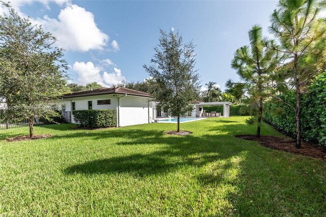 7720 SW 130th St, Pinecrest, FL 33156 - view of yard with fence and a carport