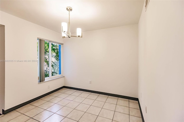 unfurnished room featuring an inviting chandelier