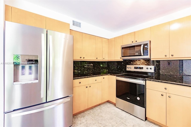 kitchen featuring backsplash, light brown cabinets, light tile patterned flooring, and stainless steel appliances