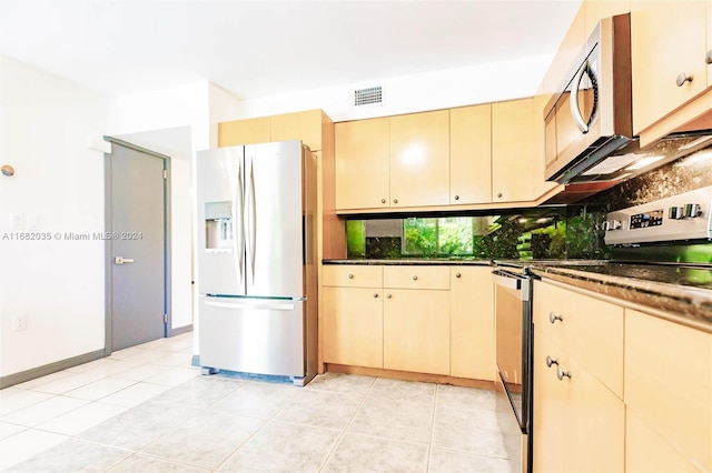 kitchen with decorative backsplash, light tile patterned flooring, and stainless steel appliances