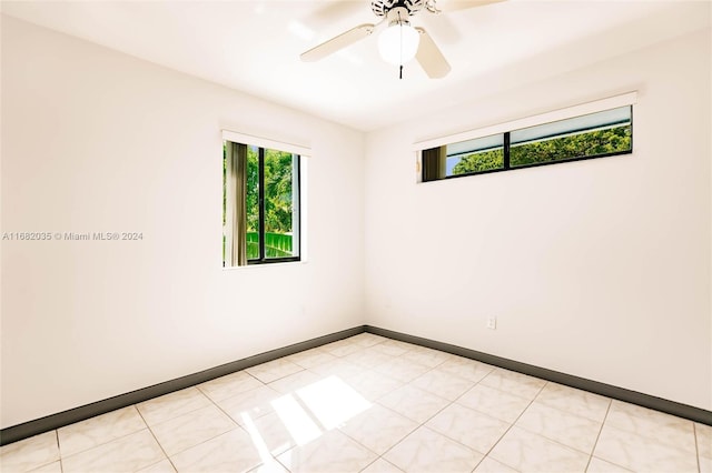 spare room featuring ceiling fan and light tile patterned flooring