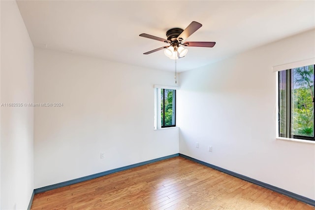 unfurnished room with hardwood / wood-style flooring and ceiling fan