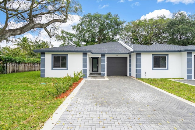 ranch-style house featuring a garage and a front yard