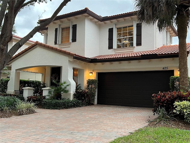 mediterranean / spanish house featuring a garage