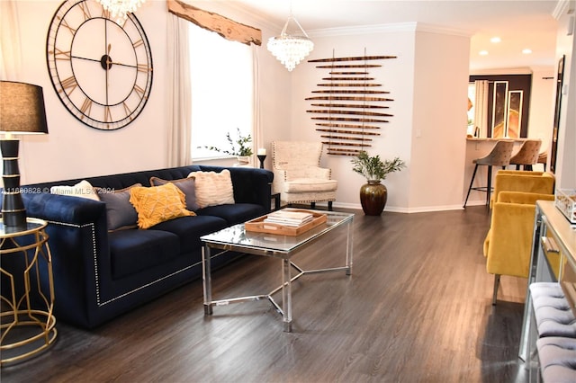 living room with ornamental molding, dark wood-type flooring, and a notable chandelier