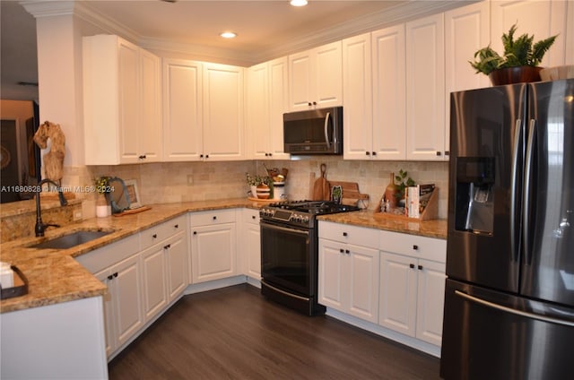 kitchen featuring light stone countertops, white cabinetry, sink, stainless steel appliances, and dark hardwood / wood-style flooring