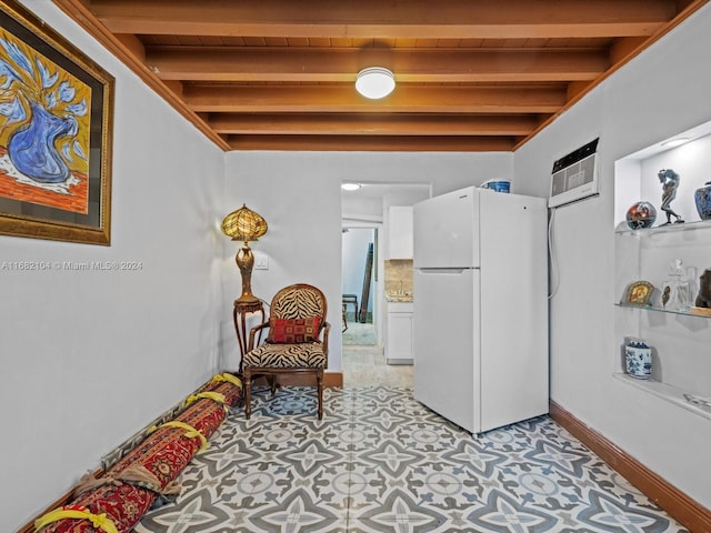 living area with an AC wall unit and beamed ceiling