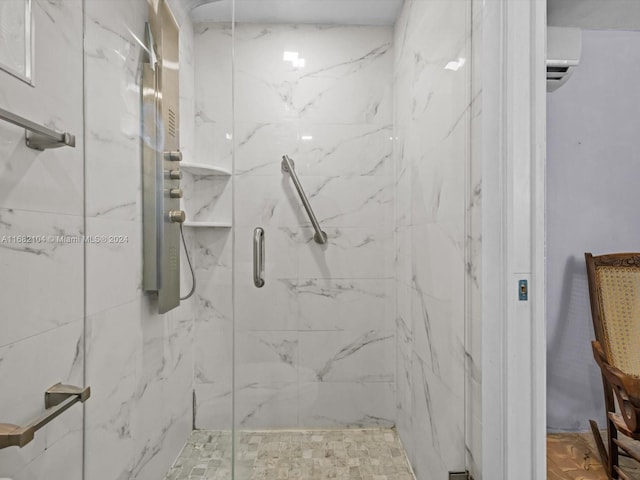 bathroom featuring an AC wall unit and a shower with shower door