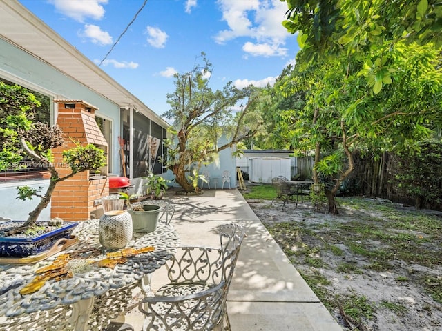 view of patio featuring a shed