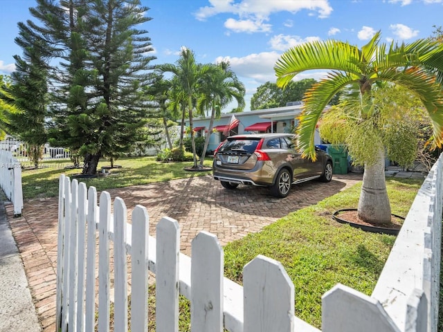 view of vehicle parking featuring a lawn