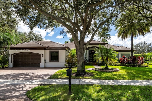 ranch-style house with a front lawn and a garage