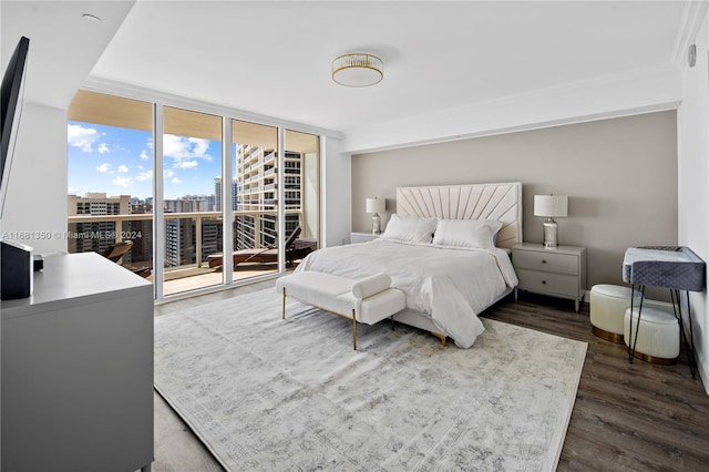 bedroom featuring dark wood-type flooring, crown molding, a wall of windows, and access to exterior