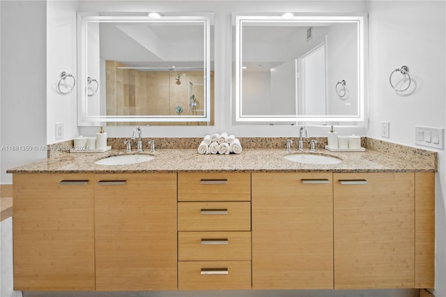 bathroom with vanity and a tile shower