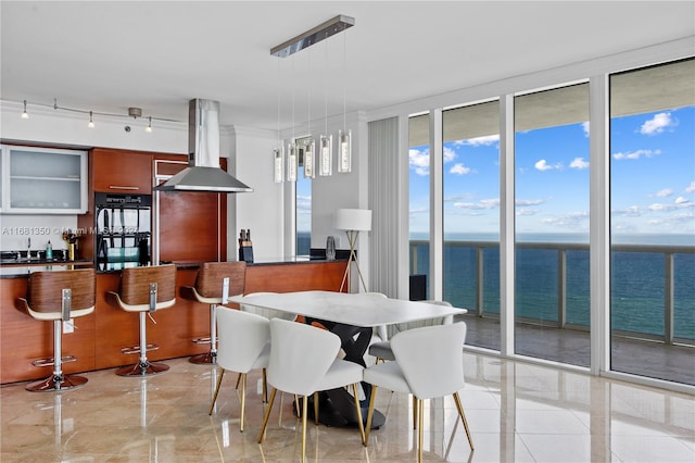 dining space with sink and a water view