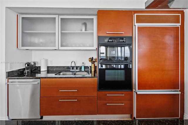 kitchen with sink, black double oven, dishwasher, and dark stone counters