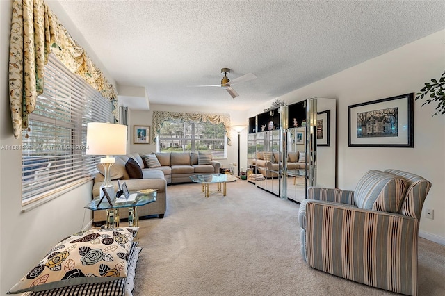 carpeted living room with a textured ceiling and ceiling fan