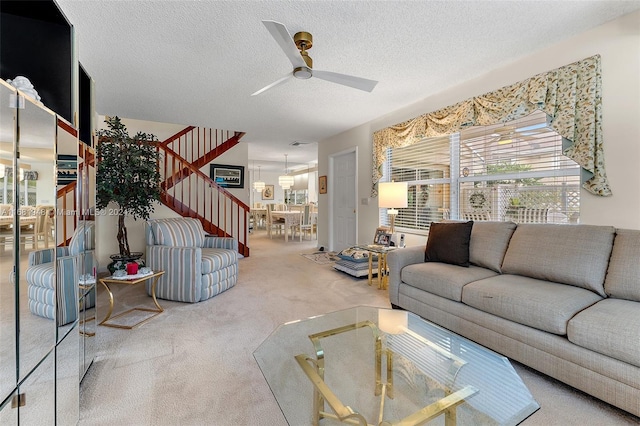 living room with carpet, a textured ceiling, and ceiling fan