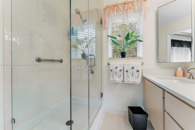 bathroom featuring vanity, tile patterned floors, and a shower with shower door