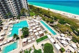 bird's eye view featuring a view of the beach and a water view