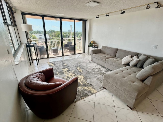 living room featuring floor to ceiling windows and a textured ceiling