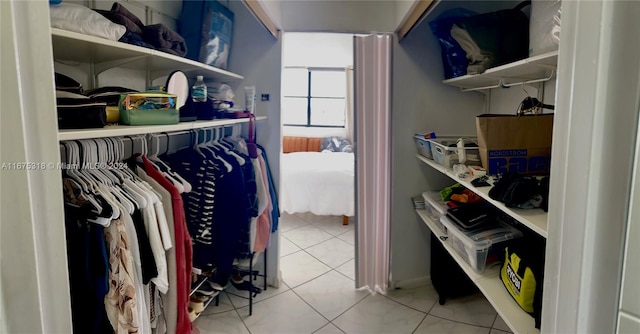 walk in closet with light tile patterned floors