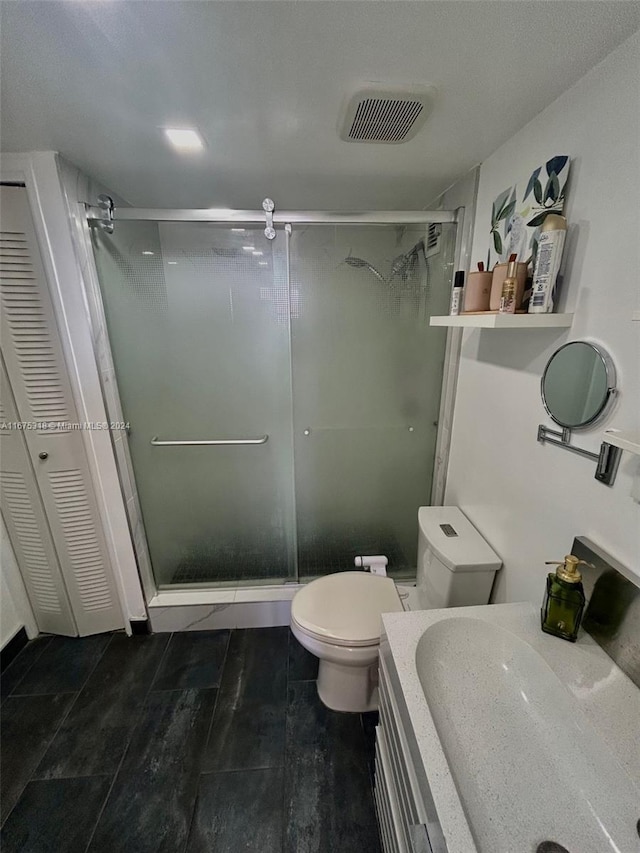 bathroom featuring toilet, sink, and walk in shower